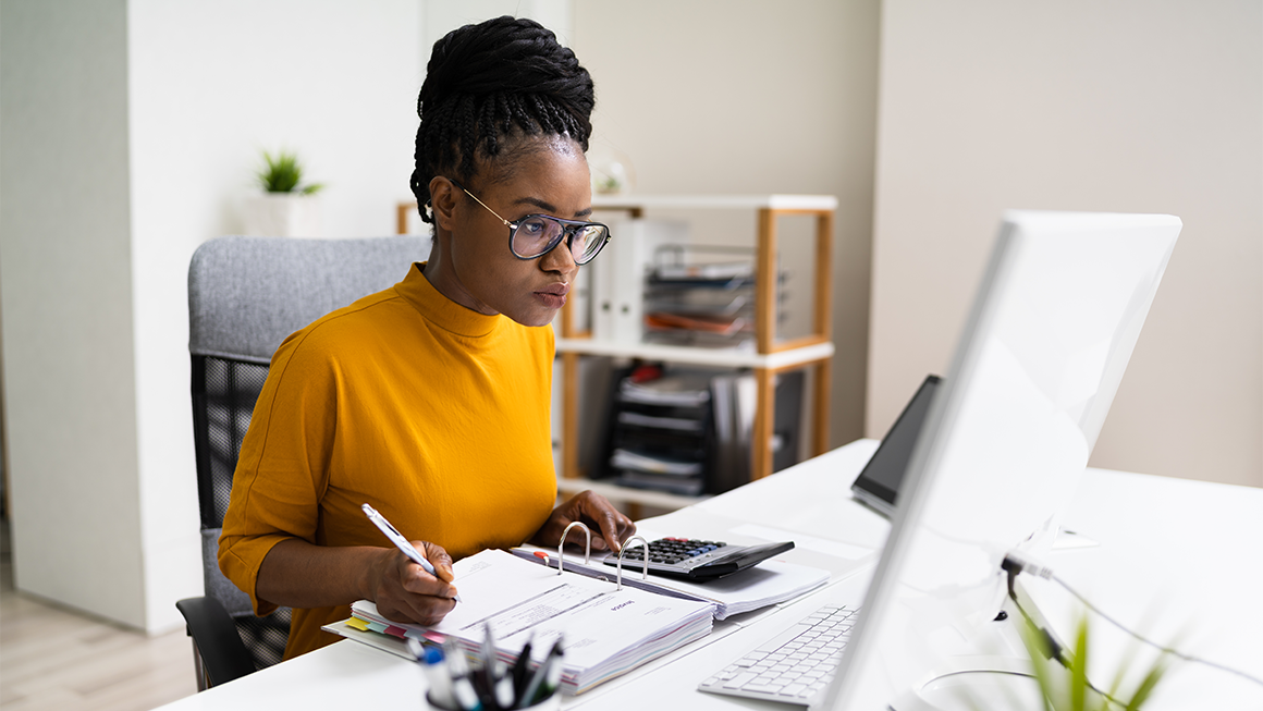 Accounting Technician sitting in front of a computer working on a project