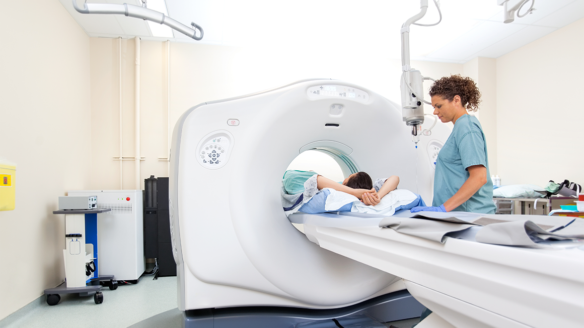 MRI Technician performing routine scan with patient